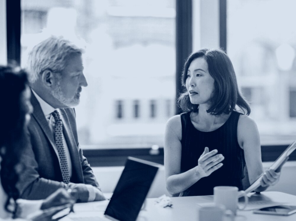 An adviser in conversation with business clients