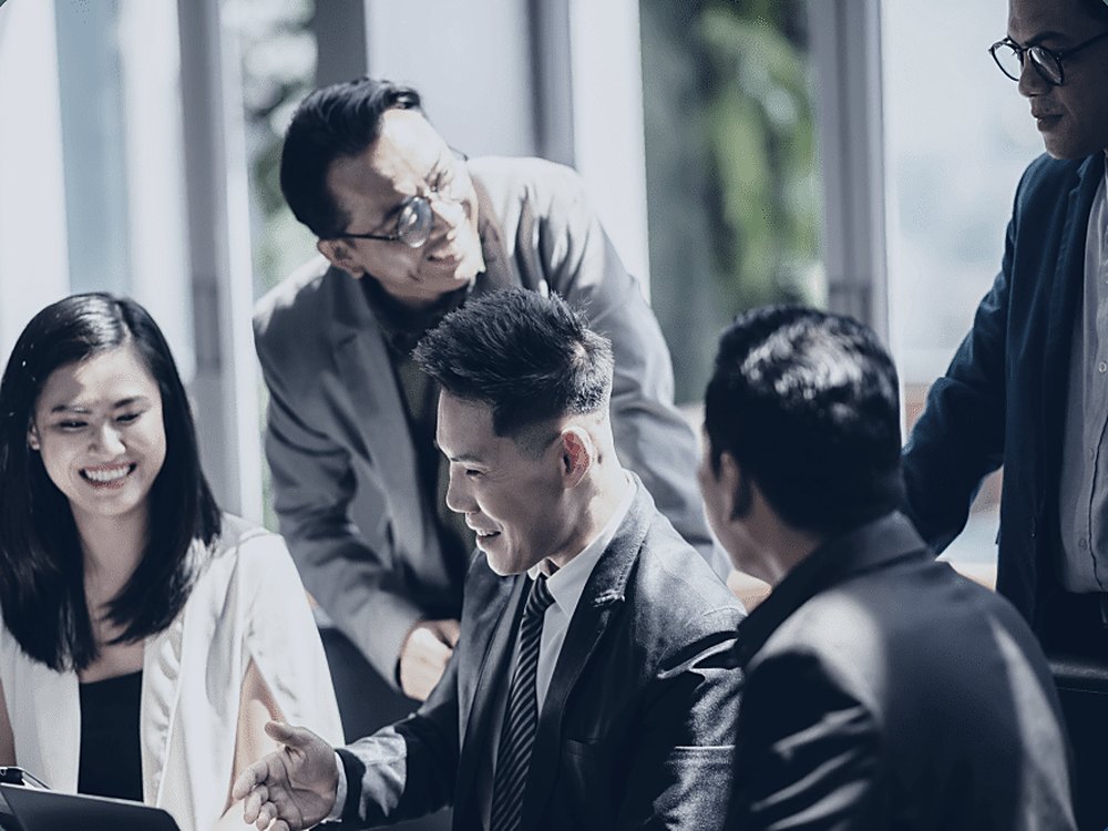 A business owner and their team in a working meeting